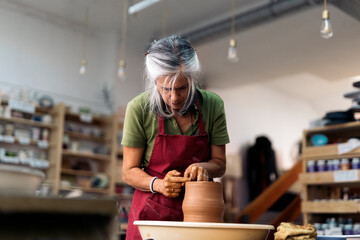 Woman Making Pottery On Spinning Wheel