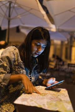 Young woman pointing at a map