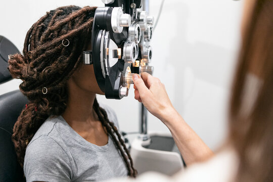 Eyewear: Woman Looks Through Phoropter To Measure Prescription