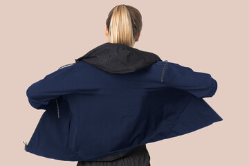 Blonde woman in windbreaker jacket for sportswear fashion photoshoot rear view © Rawpixel.com