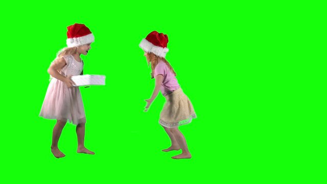 Cute little girls fighting for gift box. Chroma key green background.