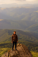 Obraz premium Young boy, tourist, portrait photos of a guy in the Carpathian mountains, picturesque and impressive Ukrainian Carpathians, view from the mountain Pip Ivan Chornohirsky.