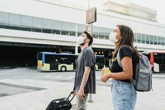 Couple at the airport wearing face masks
