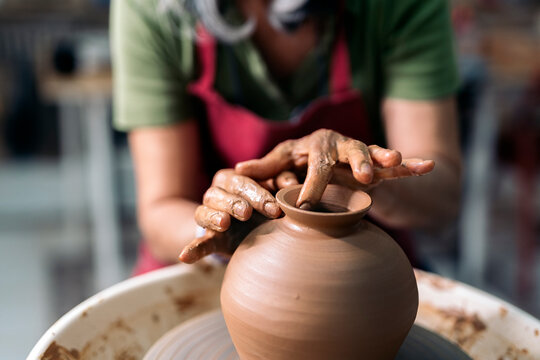 Woman Making Pottery On Spinning Wheel