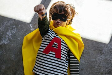 Funny superhero lying on floor