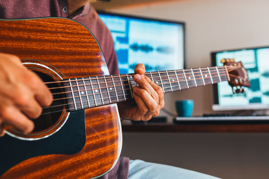Young man recording music at home music studio