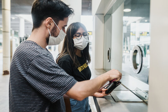 Couple at the airport wearing face masks