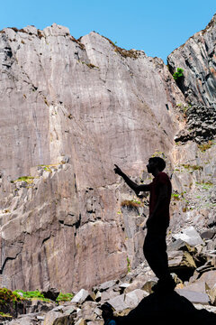 Climber climbing at stuning walls of the ancient Dinorwic Quarry at Snowdonia National Park in North Wales