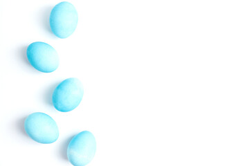 Happy Easter concept. Chicken eggs painted in blue color in the egg compartment. Preparation for holiday. White background copy space
