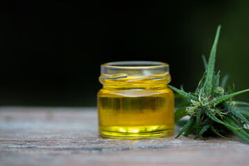 Hemp oil in a glass jar, CBD cannabis oil.Alternative herbs for medicine. copy space.