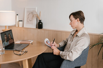 Female phycologist talking to couple on video chat via netbook