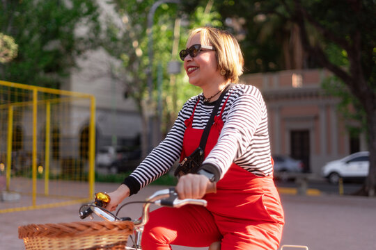 madure woman riding bike in the park
