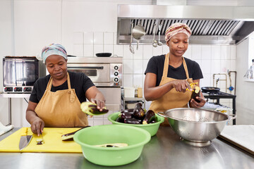Women preparing food in a catering kitchen