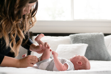 Mother checks crying infants diaper