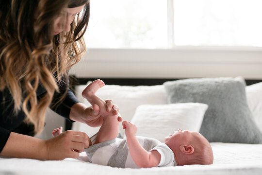 Mother checks crying infants diaper
