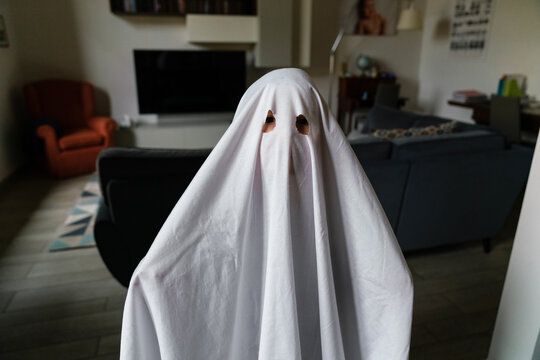 Little ghost celebrating Halloween at home