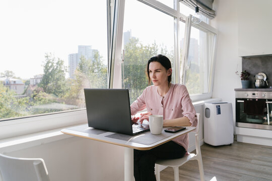 Woman Working Using Laptop Indoors