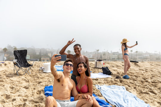 Friends Have Fun Taking Selfies At the Beach