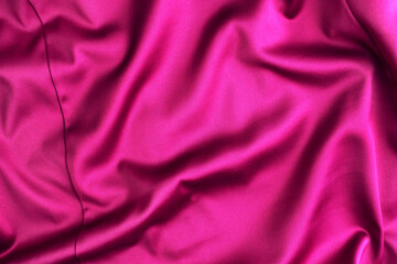 Pink crimson silk texture, background of clothing material.