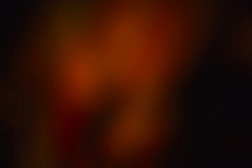 Blur colorful warm rainbow light leaks on black background with dust texture. Defocused abstract...