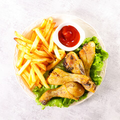 fried chicken leg, french fries and ketchup