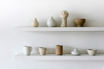 Ceramic decorations and dishware on shelves