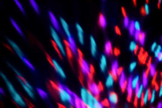 Blur colorful neon light leaks on black background. Defocused illuminated abstract futuristic texture for using over photos as overlay or screen filter