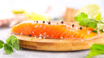 raw salmon on board with lemon and herbs