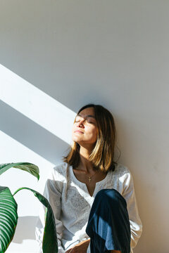 Young woman relaxing in sunlight