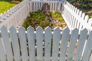 Grave inside a white picket fence
