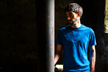 Tourist into to the walls of building in decay in quarry