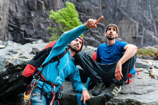Two climbers pointing to slate climbing walls