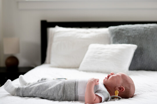 Crying newborn on bed