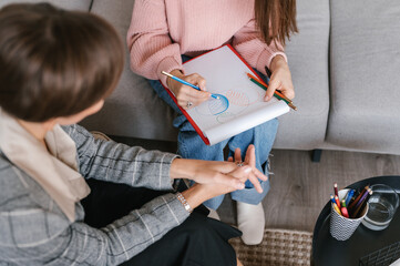 Woman drawing on paper during art therapy session