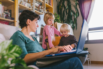Mother and little kid using gadgets at home