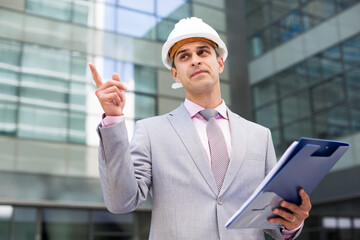 Portrait of manager of plant giving instructions and pointing with his finger