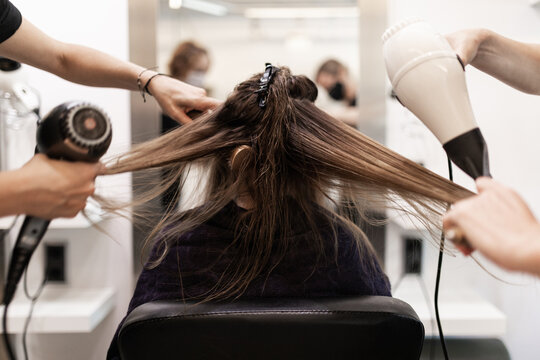 hairdressers combing a client - Powered by Adobe