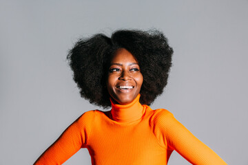 Optimistic young black woman with curly hair