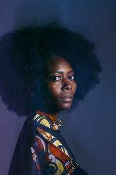 Calm black woman in dark studio