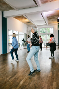 Elderly Women Dancing in Bright Studio