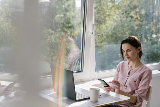 Woman Using Mobile Phone At Home