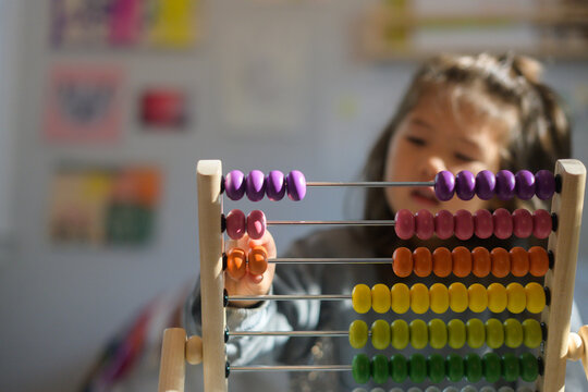 Child counting on abacus tool