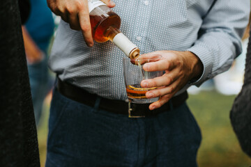 Man pouring an alcoholic liquor drink with orange
