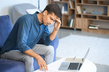 Portrait of stressed young man at home