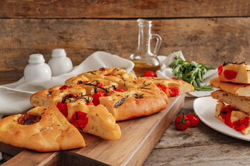 Composition with traditional Italian focaccia on wooden background