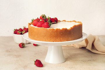 Tasty cheesecake with strawberry on table
