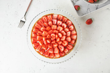 Tasty cheesecake with strawberry on white background