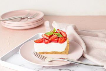 Tray with tasty cheesecake with strawberry on table