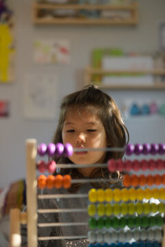 Child counting abacus beads