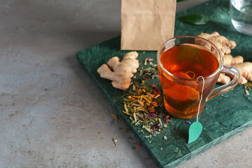 Cup of aromatic black tea on dark background